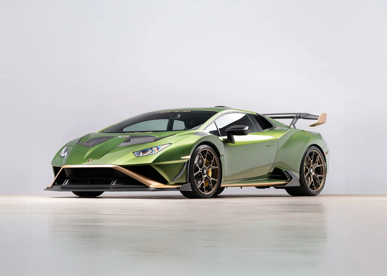Green Lamborghini Huracán STO with Vorsteiner aerodynamic components in a studio